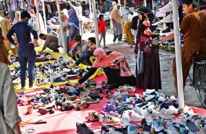 Women are busy selecting and purchasing old cloth pieces from stall at I-9/4 weekly bazaar in Federal Capital.