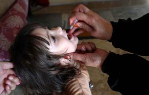 A health worker administers polio drops to a child during the anti-polio vaccination campaign at Ghouri Town in the Federal Capital.