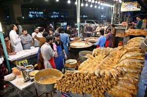 Workers are busy frying fish for customers at 6th Road as demand increases during winter season