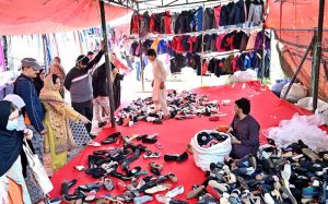 Women are busy selecting and purchasing second hand warm clothes from vendor at weekly bazaar, I-9/4 in the Federal Capital.