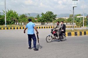 Islamabad Police official checking drivers’ identity cards and vehicle documents in the Federal Capital.