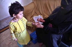 A health worker administers polio drops to a child during the anti-polio vaccination campaign at Ghouri Town in the Federal Capital.