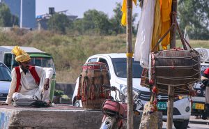 Dhol player waiting for customers at his roadside setup in the Federal Capital