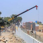 Labourers are busy construction work of T-Chowk Flyover during development work in Federal Capital