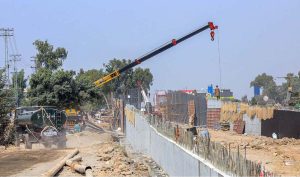 Labourers are busy construction work of T-Chowk Flyover during development work in Federal Capital