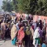 Deserving women wait in long queues to receive financial assistance under the Benazir Income Support Programme (BISP) at Government Crescent Model Higher Secondary School