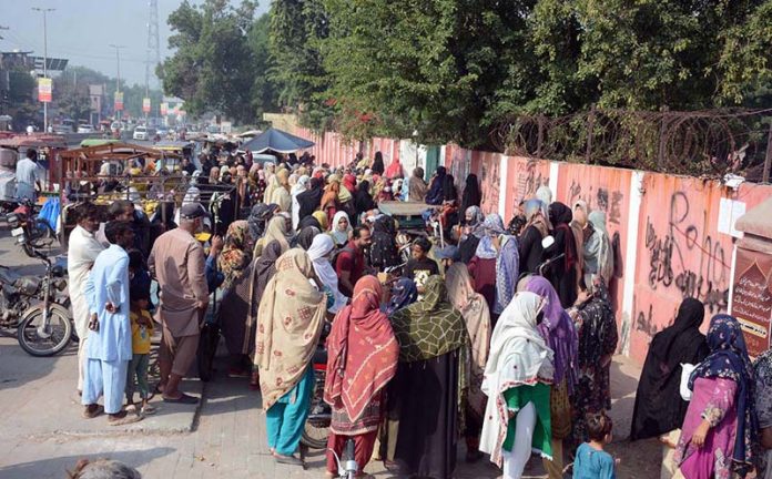 Deserving women wait in long queues to receive financial assistance under the Benazir Income Support Programme (BISP) at Government Crescent Model Higher Secondary School