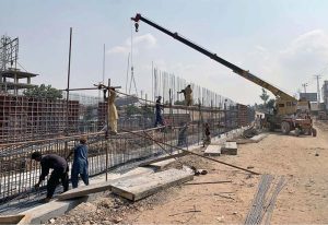Labourers are busy construction work of T-Chowk Flyover during development work in Federal Capital