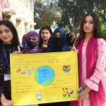 Students hold placards during an event organized by the Institute of Food Science and Nutrition at the University of Sargodha in connection with World Food Day