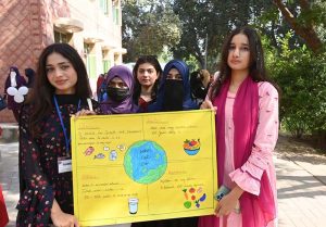 Students hold placards during an event organized by the Institute of Food Science and Nutrition at the University of Sargodha in connection with World Food Day