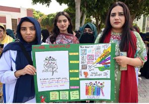 Students of the Department of Psychology and Counseling Center holding a banner during an awareness walk organized on the occasion of World Mental Health Day 2025 at the University of Sargodha.