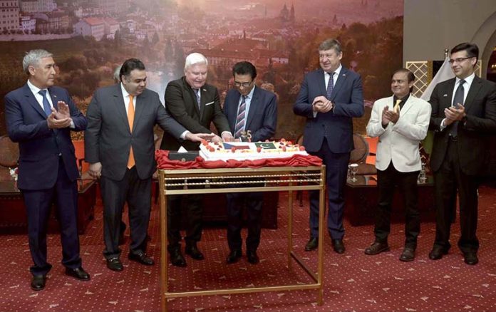 Federal Minister for Education and Professional Training, Dr. Khalid Maqbool Siddiqui, Minister of State / Special Assistant to the Prime Minister on Digital Media, Fahd Haroon and others join Ladislav Steinhübel, Ambassador of the Czech Republic to Pakistan to cut cake during a reception hosted by the Embassy of the Czech Republic in Islamabad to commemorate the Czech National Day and the 75th anniversary of diplomatic relations between the Czech Republic and Pakistan