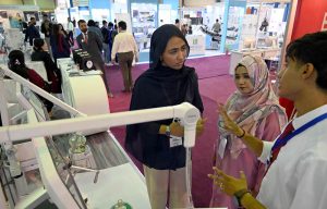 Visitors take interest in a stall during the second day of the Health Asia Exhibition at the Expo Centre