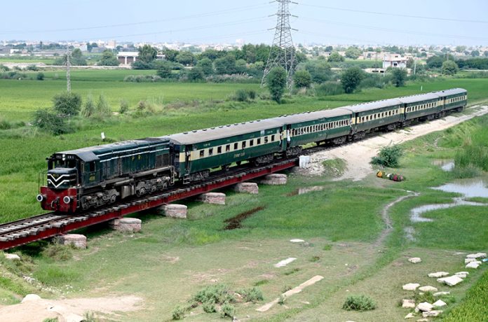 A view of the Mohenjo Daro passenger train passing through near the bypass on the way from Larkana to Kotri