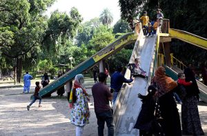 Children enjoying slide swing at Jinnah Park.