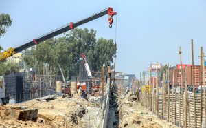 Labourers are busy construction work of T-Chowk Flyover using heavy machinery during development work
