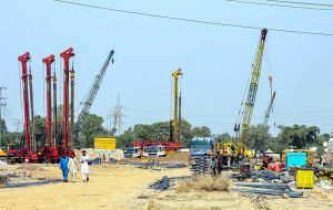 Labourers are busy construction work of T-Chowk Flyover using heavy machinery during development work