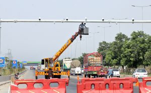 An engineer repairing security cameras on the road in federal capital.