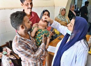 Lady Doctor administering polio drops to a child during anti-polio vaccination campaign at Government Bhitai Hospital