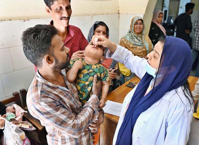 Lady Doctor administering polio drops to a child during anti-polio vaccination campaign at Government Bhitai Hospital