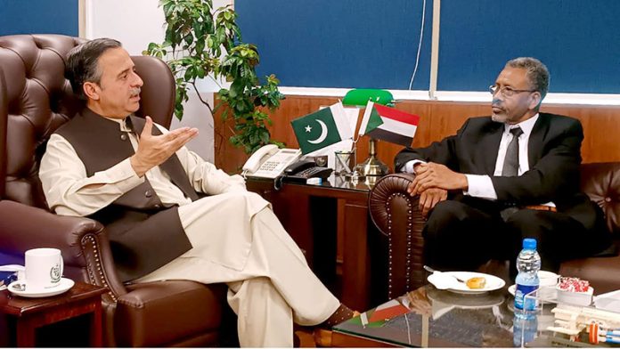 Federal Minister for Maritime Affairs Muhammad Junaid Anwar Chaudhry talking to Sudan's Ambassador, Salih Mohamed Ahmed Mohamed Siddig, who called on him