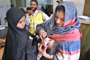 Lady Doctor administering polio drops to a child during anti-polio vaccination campaign at Government Bhitai Hospital