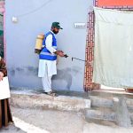 CBH worker spraying anti-dengue chemical outside a house at Kumhar Para