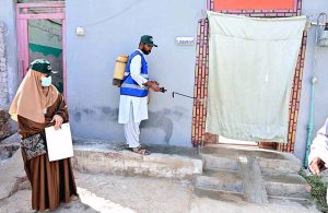 CBH worker spraying anti-dengue chemical outside a house at Kumhar Para
