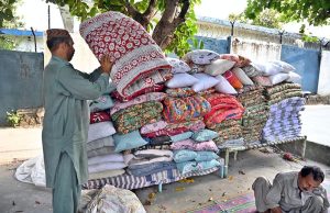 A worker busy in stitching quilt for customers at his workplace G-7 Sector in the Federal Capital.