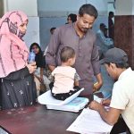 A medical staffer weighting a child at Bhitai Hospital