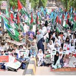 Students of different schools participating in Children Gaza March organized by Jamat-e-Islami Hyderabad outside Press Club Road.