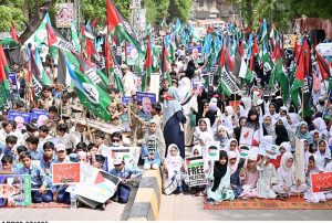 Students of different schools participating in Children Gaza March organized by Jamat-e-Islami Hyderabad outside Press Club Road.