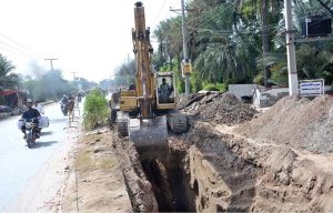 WASA workers are laying new WASA pipeline on Millat Road with heavy machinery