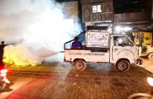 CBH worker busy in spraying anti-dengue fume during malaria & anti- dengue spray campaign at Pathan Colony