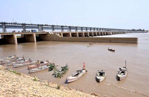 Fisherman preparing fishing net for fishing while sitting on the boat at Indus River.