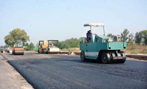 Labourers are busy in construction work of Sargodha Road with the help of heavy machinery during development work in the city.