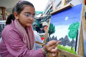 Female participating in mehndi competition during an Event on “Integrated Sports, Theatre, and Arts Activities for Creative Healing and Resilience” organized by The Department of Social Welfare Merged Districts, with the support of UNICEF