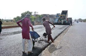 Labourers are busy in construction work of Sargodha Road with the help of heavy machinery during development work in the city.
