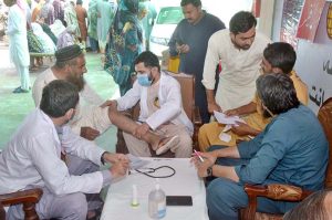Doctor examine the patients during 8th Free Medical Camp in Moza Qazian for flood affected people arranged by Islamia Hospital.