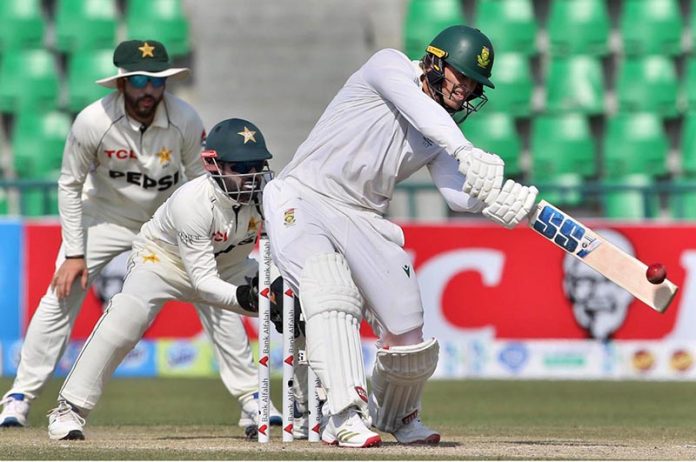 South African batsman Ryan Rickelton hits the ball for high score during the second day of the first Test match between Pakistan and South Africa at the Gaddafi Stadium