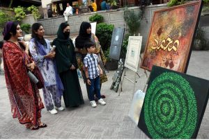 Visitors viewing a painting and calligraphy exhibition at Masjid Wazir Khan Square, organized in collaboration with The Knowledge of Art Academy and the Walled City of Lahore Authority.