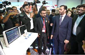 Federal Minister for Health Syed Mustafa Kamal along with others cutting the ribbon to inaugurate the Health Asia Exhibition at Expo Center.