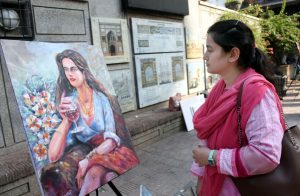 Visitors viewing a painting and calligraphy exhibition at Masjid Wazir Khan Square, organized in collaboration with The Knowledge of Art Academy and the Walled City of Lahore Authority.