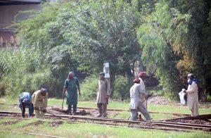 Railways workers busy in work to clear the railway tracks near Railway Station.