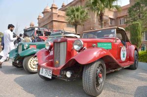 Visitors take interest in vintage cars displayed during the Vintage Classic Car Show at the museum.