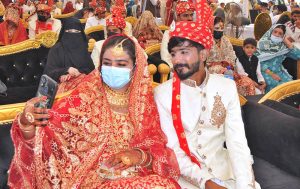 Brides in a group photo during a mass marriage ceremony held under the “Punjab Dhee Rani Program” at Sports Ground.