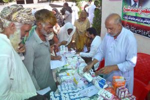 Doctor examine the patients during 8th Free Medical Camp in Moza Qazian for flood affected people arranged by Islamia Hospital.