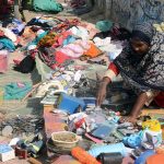 A woman vendor sells used household items at his roadside setup in the Provincial Capital.