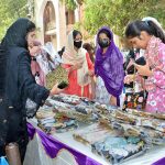 Students take interest in handmade embroidered items displayed at different stalls during the two-day Sports Gala at Women University, Katchery Campus.