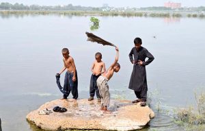 Youngsters busy in washing their clothes in stagnant water at GCT ground.